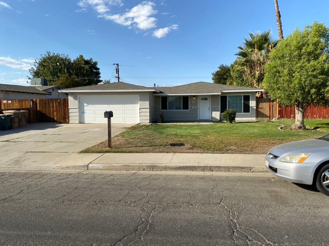 Renovated home exterior after cash purchase in Bakersfield
