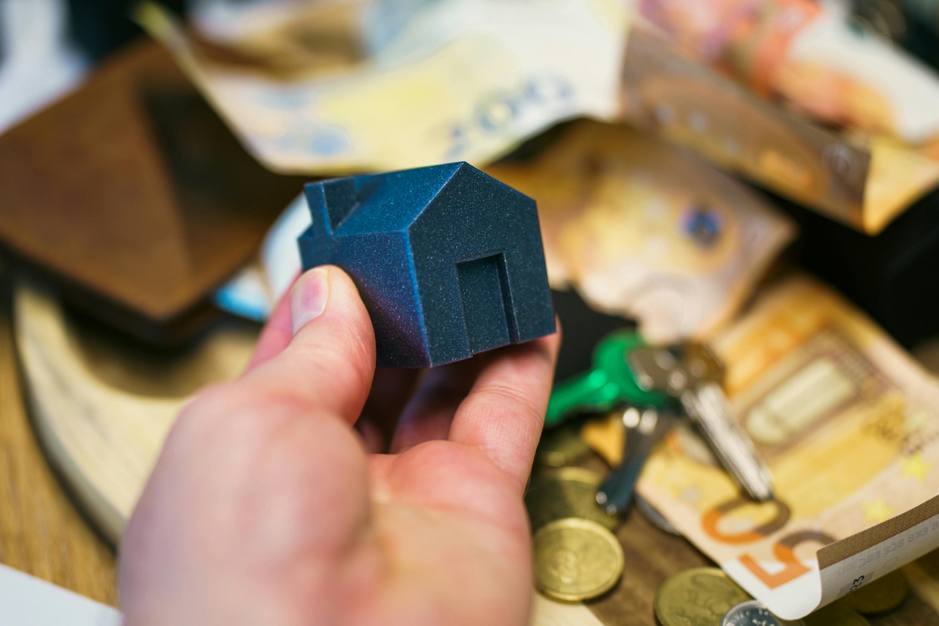 House model with money and keys - selling rental property
